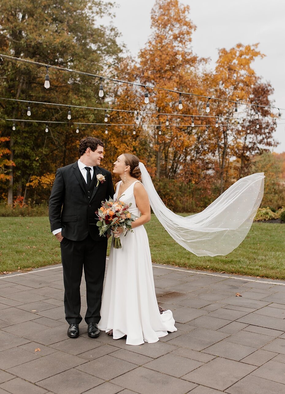 A Lace bride and her partner celebrating their wedding outdoors